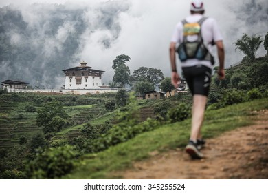 Bhutan Monastery With Runner In Foreground