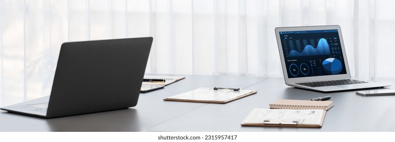 BI data dashboard from Fintech on laptop screen displays comprehensive business analysis in empty office. Technology empowering business financial data visualization and growth strategy. Prodigy