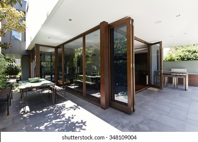 Bi Fold Doors Opening To Rear Courtyard Of Contemporary Australian Home