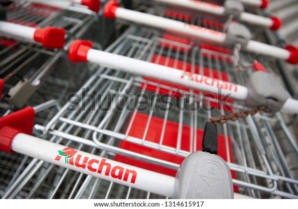 Bialystok/Poland\
February 12, 2019 \
View of Auchan supermarket logo, entrance and\
parking.Auchan is a French international supermarket chain, is one\
of the largest distribution\
groups.