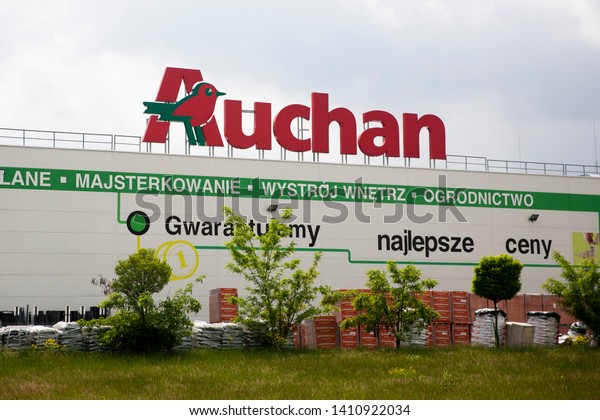 Bialystok/Poland May\
29, 2019 \
View of Auchan supermarket logo, entrance and\
parking.Auchan is a French international supermarket chain, is one\
of the largest distribution\
groups.