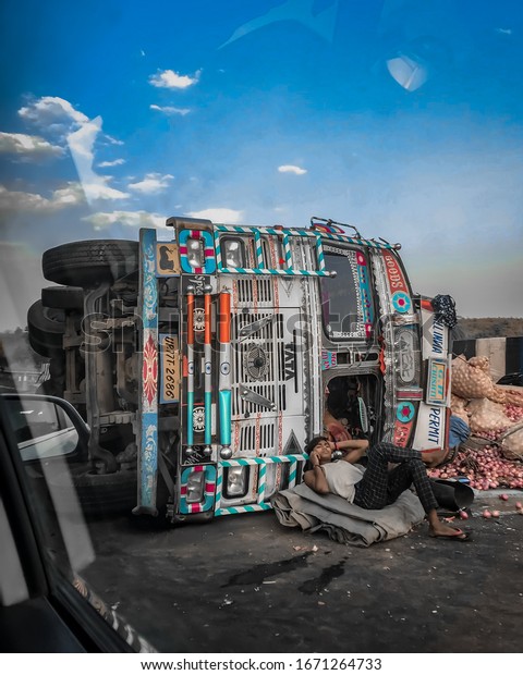 Biaora, India - Jun 3, 2019: A man lying
worry free in front of his truck after
accident.