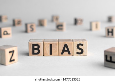 Bias - word from wooden blocks with letters, personal opinions prejudice bias concept, random letters around, white  background