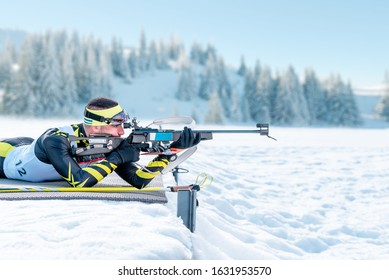 Biathlete shoots in the prone position on training ground