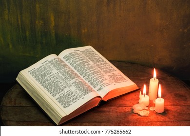 open bible with candle