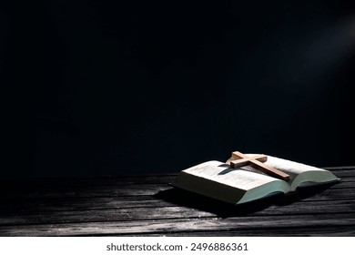 Bible and cross on black wooden table against dark background, space for text. Religion of Christianity - Powered by Shutterstock