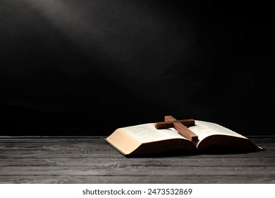 Bible and cross on gray wooden table against dark background, space for text. Religion of Christianity - Powered by Shutterstock