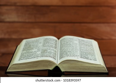 Bible and a crucifix on a black glass table. Beautiful background.Religion concept. - Shutterstock ID 1018393597