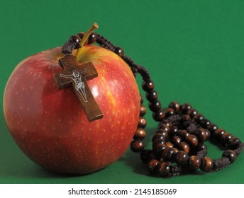 Bible Eva's Sin Red Apple over a Colored Background