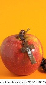 Bible Eva's Sin Red Apple over a Colored Background