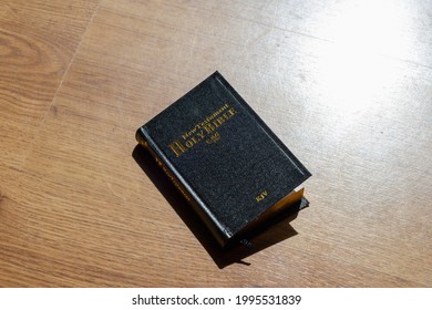 Bible in the light wooden background. The Holy Bible.The Old Holly Bible closed.Black holly Bible on a table.