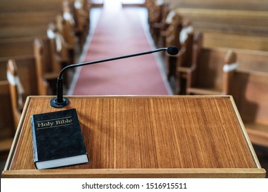 bible on church pulpit, with view over the empty pews in the church - Shutterstock ID 1516915511