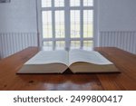 The Bible placed on the table was opened for learning to understand the Bible in order to pray to God and to ask God to protect himself and his family. The concept of Bible learning and faith in God