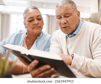 Bible, praying or old couple reading a book together in a Christian home in retirement with hope or faith. Jesus, religion or belief with a senior man and woman in prayer to god for spiritual bonding