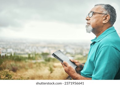 Bible, praying or senior man in nature for praise, hope or Christian religion with holy mindfulness. Prayer moment, calm pastor or mature person in worship with faith, spiritual and sky mockup
