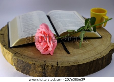 A bible with a rose and a mug. Bible study concept.