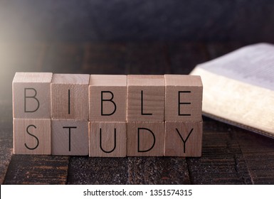 Bible Study Spelled in Block Letters on a Wooden Table with a Bible
