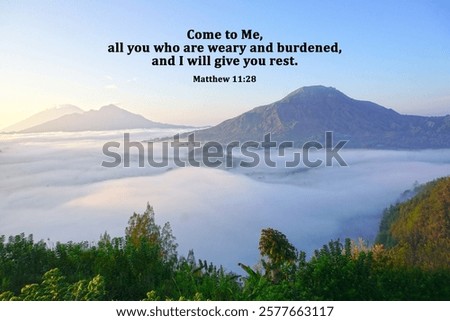 Bible verse quote - Come to me, all you who are weary and burdened, and I will give you rest. Matthew 11:28 On blue mountain nature background with morning light and the fog at sunrise. Christianity.