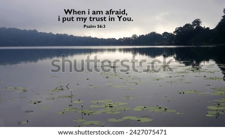 Bible verse quote Psalm 56:3 - When i am afraid, i put my trust in You. With peaceful morning in the lake with calm water and light of sunrise background. Christianity spiritual concept.