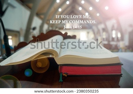 Bible verse quote - If you love me, keep my commands. John 14:15 on background of open page of bible book and light in the church. Christianity bible verses concept.