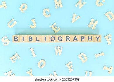 Bibliography part of a book concept. Wooden blocks typography word flat lay in blue background