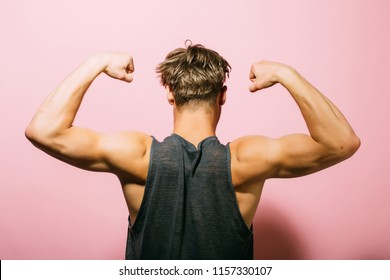 Biceps Concept. Athlete Show Biceps And Triceps, Back View. Man Flex Arms With Biceps. Biceps Muscle Of Arms.