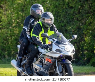 Bicester, Oxon, UK - April 15th 2022. Suzuki Gsx-R Motorcycle With Rider And Pillion Passenger