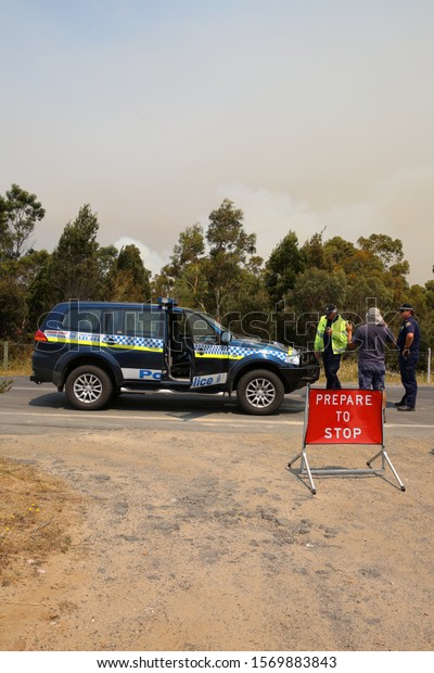 Bicheno,\
Australia - January 6, 2013: Police and State Emergency Service at\
the Road to Coles Bay. Firefighters have closed the Road and try to\
control the fires . Tasmania.\
Australia