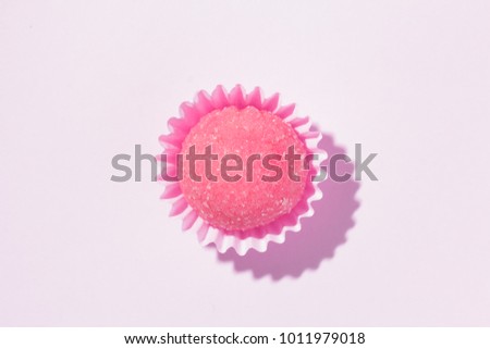 Bicho de pe is a strawberry flovoured brazilian candy. Common in children birthday parties sweet. Top view of candy on pink background.