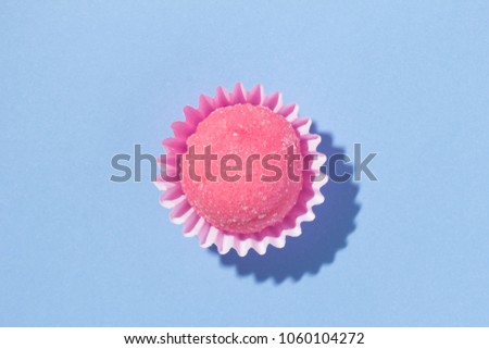 Bicho de pe is a strawberry flovoured brazilian candy. Common in children birthday parties sweet. Top view of candy on blue background.