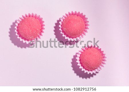 Bicho de pe is a strawberry flovoured brazilian candy. Common in children birthday parties sweet. Top view of candy on pink background.