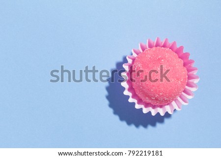 Bicho de pe is a strawberry flovoured brazilian candy. Common in children birthday parties sweet. Top view of candy on blue background.