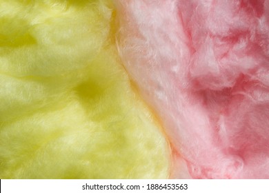 Bicolor cotton candy (fairy floss) as a background. Yellow and pink cotton candy full frame