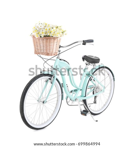 Bicycle with basket of beautiful flowers on white background