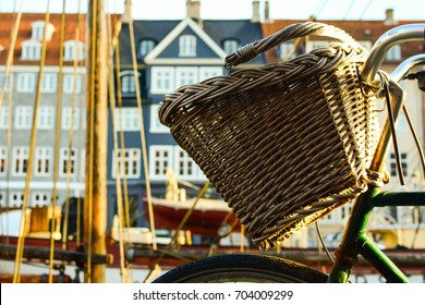Bicycle with basket on Nyhavn (New Harbour) in Copenhagen, Denmark. Colorful old town architecture. Copenhagen style, European street, Denmark bicycle