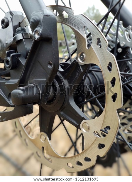 Bicycle brake disc on \
bokeh background.