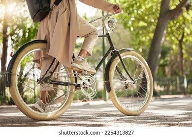 Bicycle, closeup and feet of casual cyclist travel on a bike in a park outdoors in nature for a ride or commuting. Exercise, wellness and lifestyle student cycling as sustainable transport - Shutterstock ID 2254313827