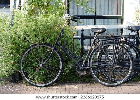 Similar – Fahrräder in der Nähe von niederländischen Häusern in Amsterdam City