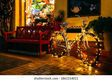 A bicycle decorated for the Christmas holidays on a night street in Zelenogradsk.