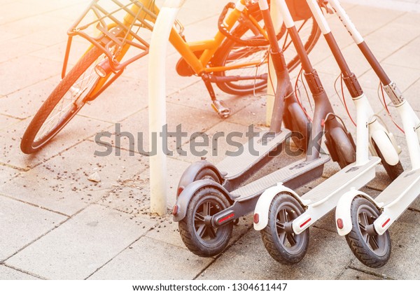 Bicycle Electric Scooters Parked On City Royalty Free Stock Image
