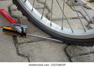 Bicycle Flat Tire On Road With Screwdriver.