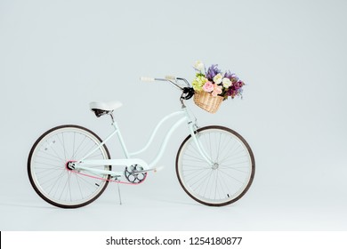 bicycle with flower basket isolated on grey