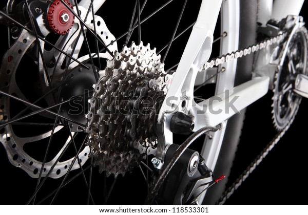 Bicycle gears, disc brake and rear derailleur.
Studio shot on black
background