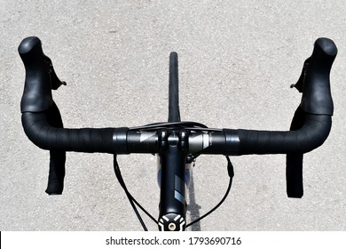 Bicycle handlebar from above as the cyclist sees it during a ride
