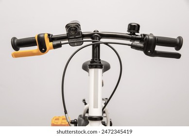 Bicycle handlebar front view close-up, with brake levers and bell. - Powered by Shutterstock