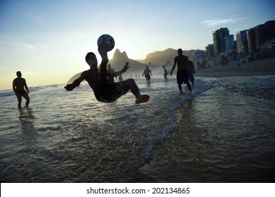 Bicycle kick silhouette playing keey upppy altinho beach football soccer on Ipanema Beach Rio de Janeiro Brazil