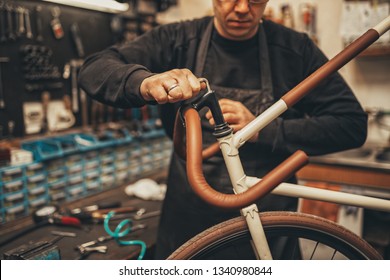 Bicycle mechanic in a workshop in the repair process. - Powered by Shutterstock