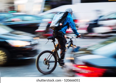 Bicycle Messenger In Busy City Traffic