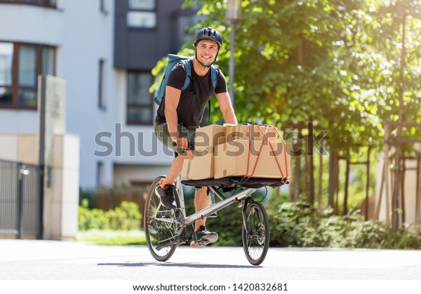 Bicycle\
messenger making a delivery on a cargo\
bike