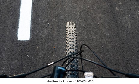 Bicycle On The Bike Path Top View Of The Front Wheel.